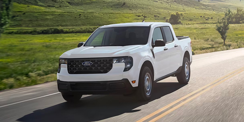 A 2025 Ford Maverick driving down a road in Minneapolis, MN