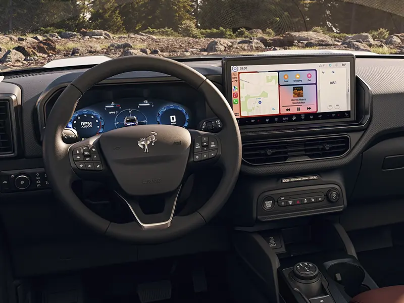 Car interior with steering wheel and touchscreen displaying navigation