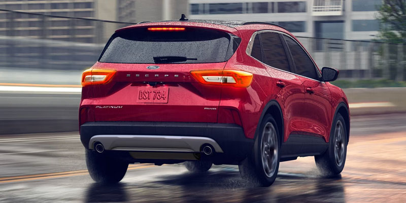 Red Ford SUV driving in city