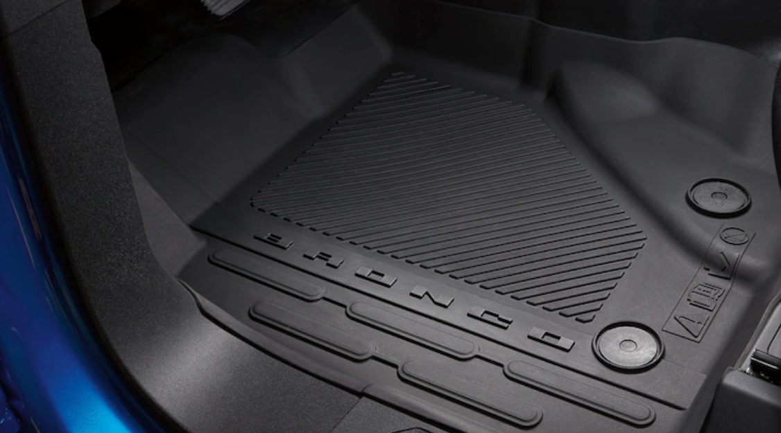 Close-up of a rubber floor mat with the 'BRONCO' logo, showing the textured surface design for added grip