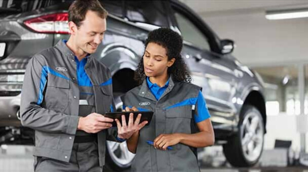 Technicians discussing vehicle service