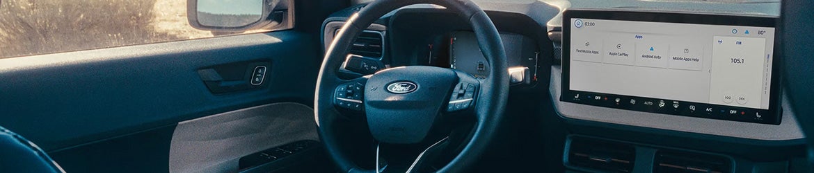 2026 Ford Maverick in Bloomington, MN interior highlighting leather-wrapped steering wheel with integrated controls and driver-focused layout.